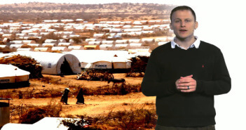 Mitreden beim Klimawandel: kostenfreier Online-Kurs zum UN-Klimagipfel in Paris Daniel Otto, wissenschaftlicher Mitarbeiter bei infernum, steht vor einem Foto eines Flüchtlingscamps und spricht zum Zuschauer.